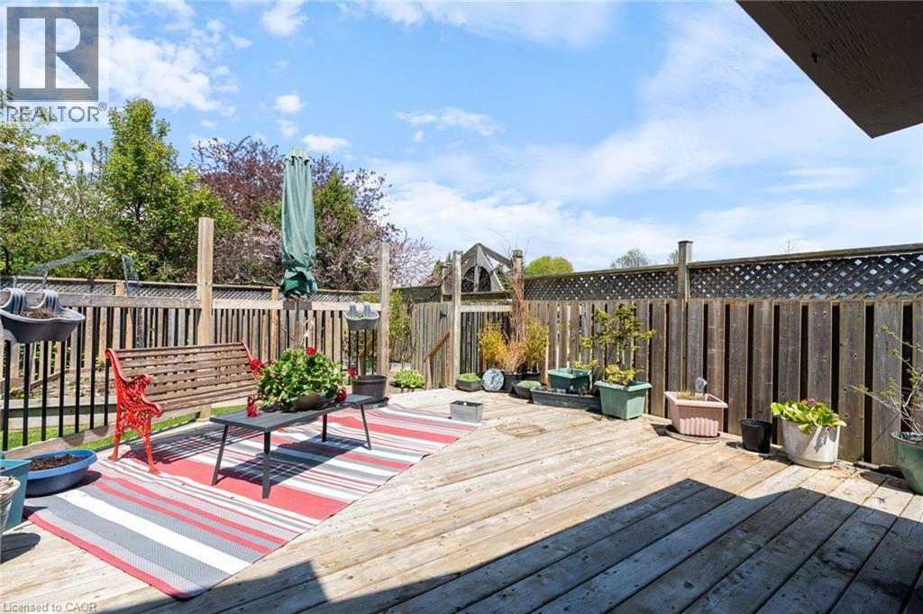 Expansive wood deck featuring a privacy fence, lattice details, and a partial outdoor gate - 2 Hampton Court, Port Dover, ON - Outdoor With Deck Patio Veranda