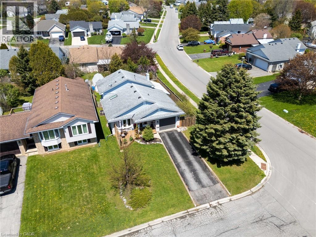 Ranch-style residence featuring a light-colored shingle roof and a paved driveway - 2 Hampton Court, Port Dover, ON - Outdoor