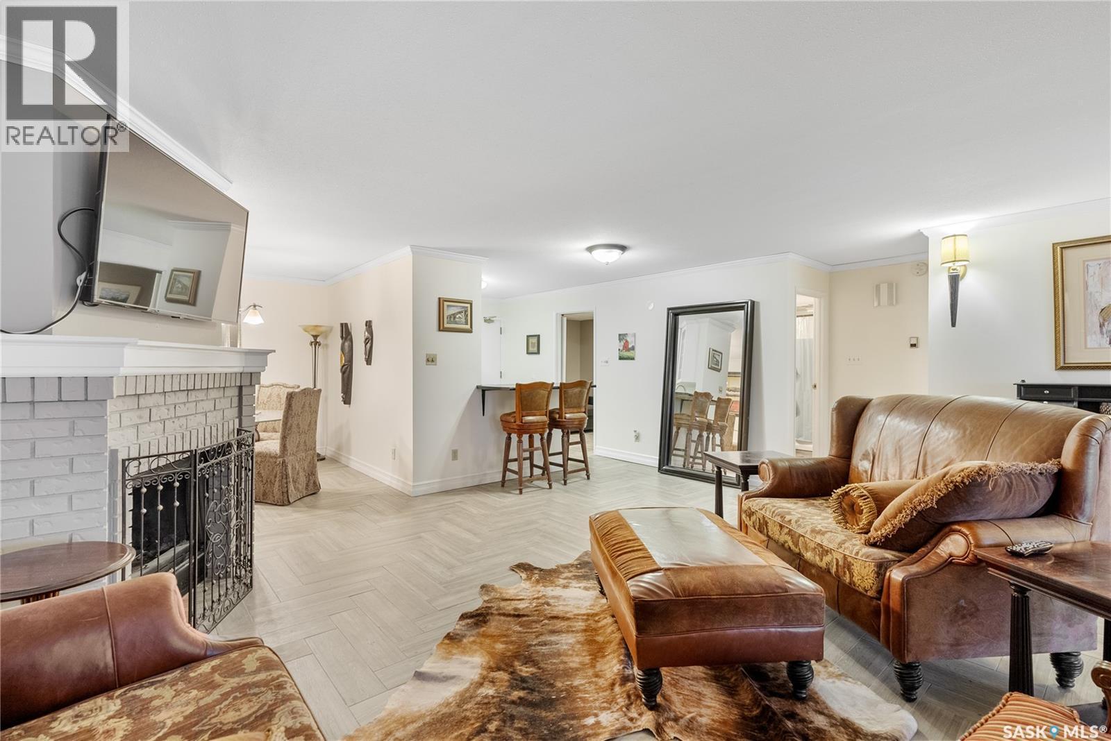 102 222 Saskatchewan Crescent E, Saskatoon, SK - Indoor Photo Showing Living Room With Fireplace