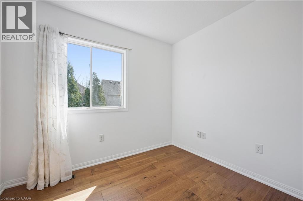 Bright room featuring wood-finish flooring and white walls - 5147 Ravine Crescent, Burlington, ON - Indoor Photo Showing Other Room