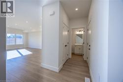 Light wood-finish flooring throughout, complemented by crisp white baseboards and trim -