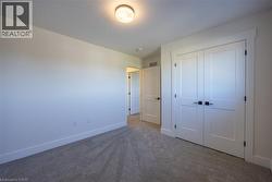 Neutral wall color palette with bright white trim and soft gray carpeting -