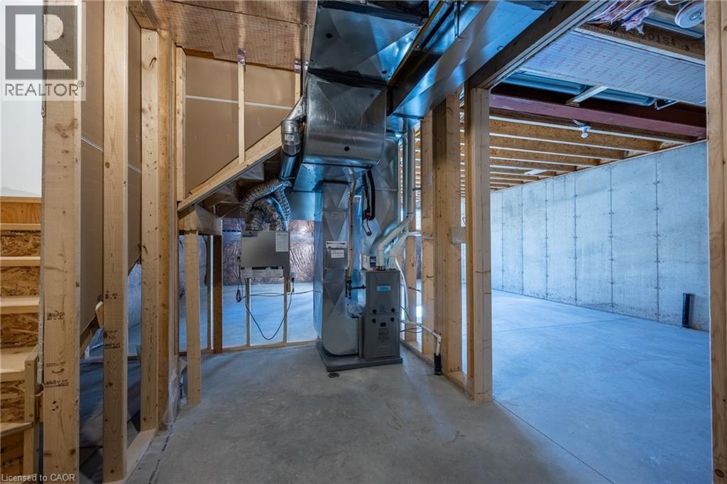 Unfinished basement featuring exposed framing, concrete flooring, foundational walls, and visible HVAC ductwork - 111 Amber Street, Waterford, ON - Indoor