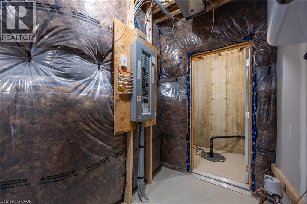 Utility space featuring insulation, an electrical panel, and a sump pump - 111 Amber Street, Waterford, ON - Indoor Photo Showing Basement