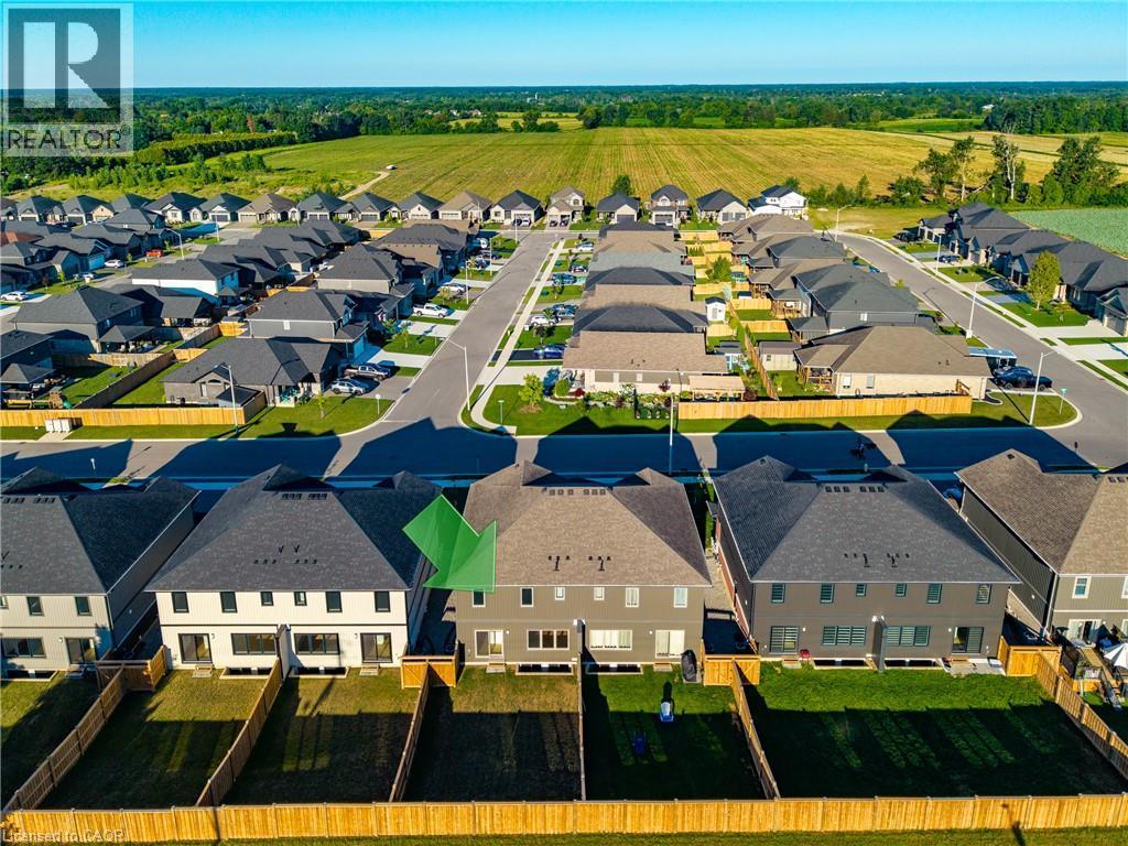Contemporary residential development featuring a structured street layout, uniform housing designs, and distinct backyard spaces - 115 Amber Street, Waterford, ON - Outdoor With View