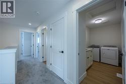 Dedicated laundry area featuring wood-finish flooring and a built-in vanity with countertop -