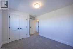Neutral-toned carpet flooring and white walls create a versatile interior space -