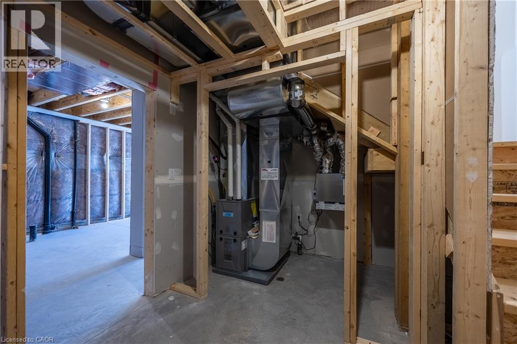 Unfinished basement with exposed wood framing, concrete flooring, and visible HVAC system - 115 Amber Street, Waterford, ON - Indoor Photo Showing Basement