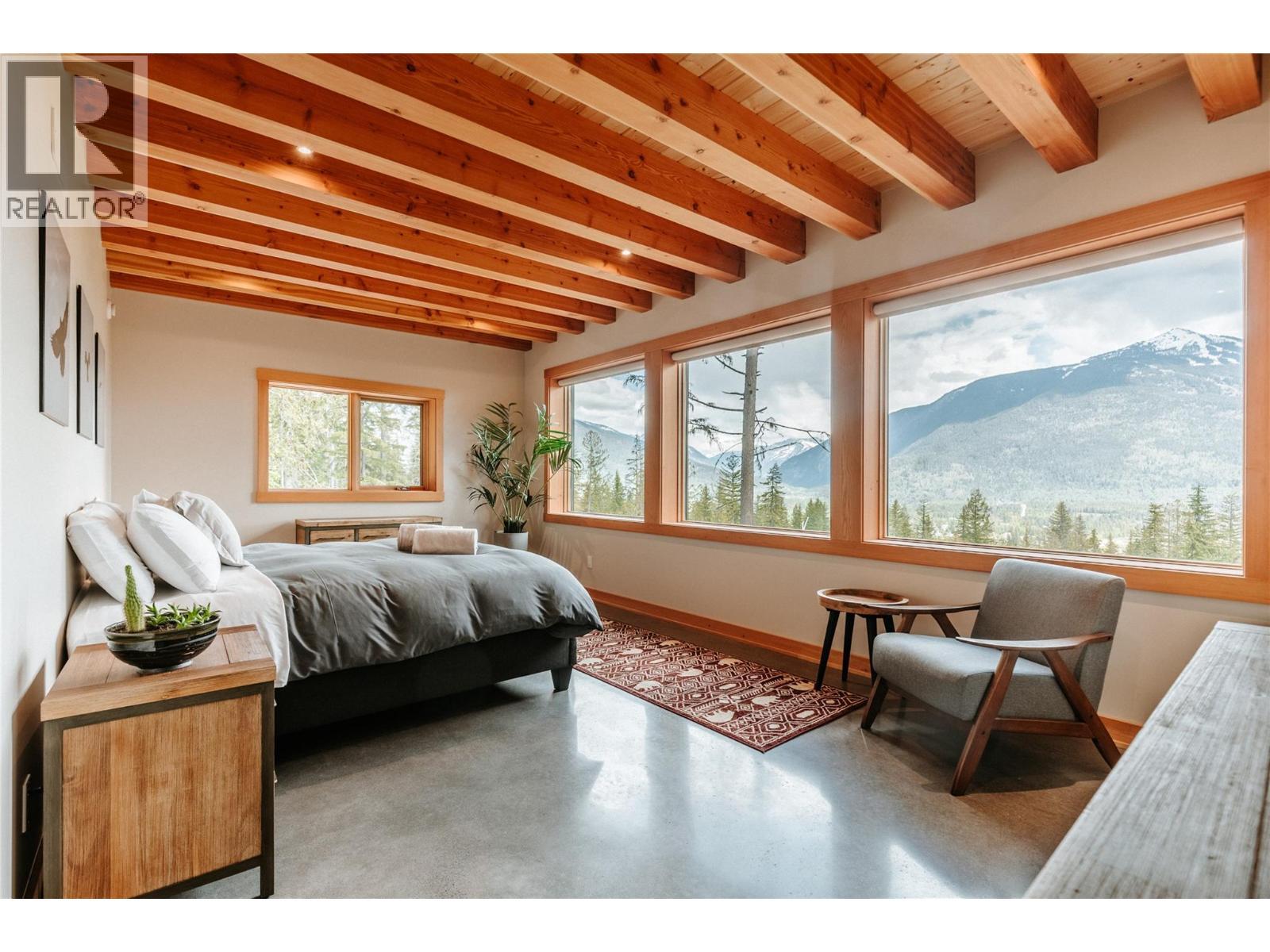 Main flr primary bdrm - 1917 Mt Mcpherson Drive, Revelstoke, BC - Indoor Photo Showing Bedroom