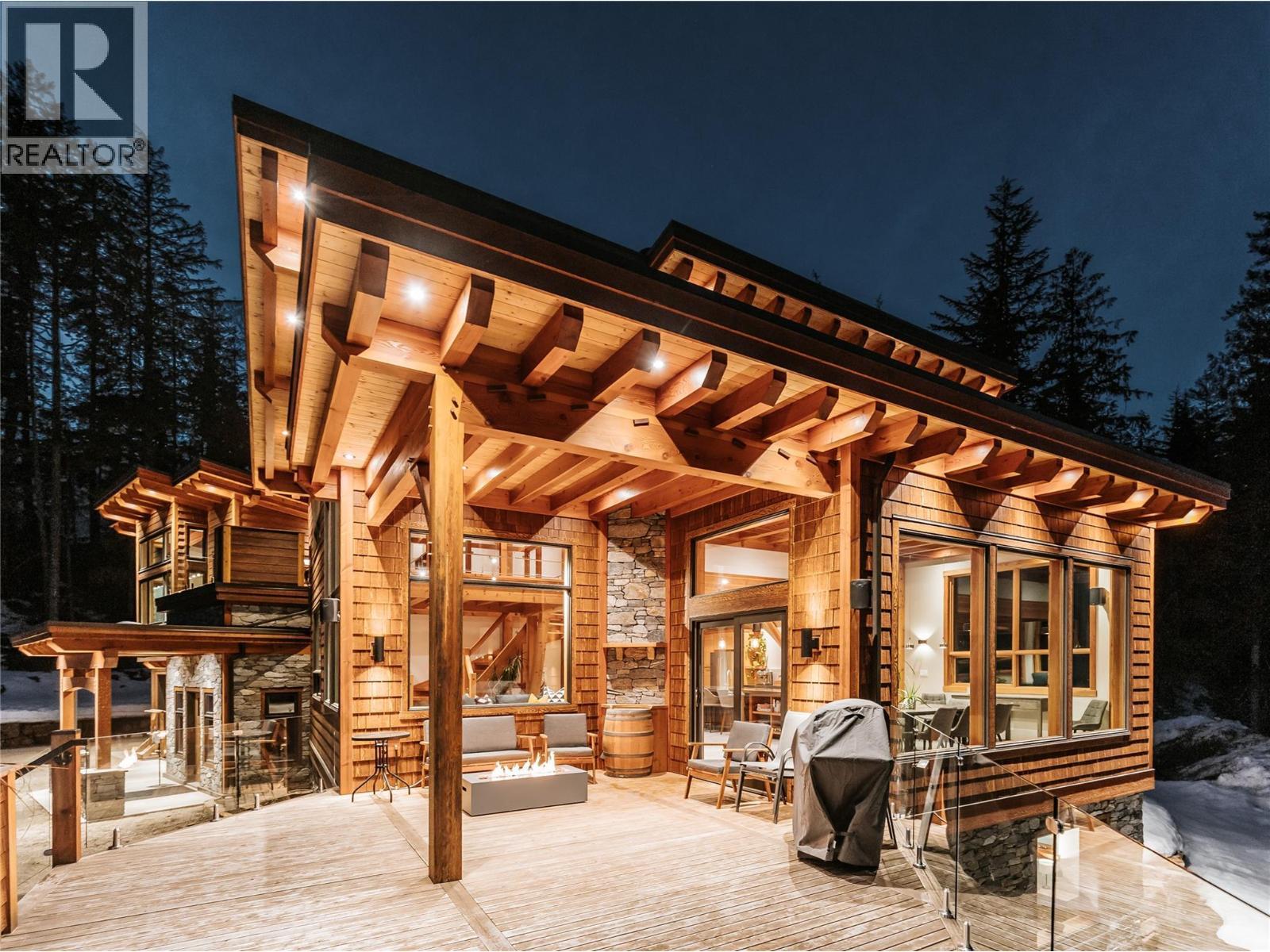 Winter nights on the deck+firepit - 1917 Mt Mcpherson Drive, Revelstoke, BC - Outdoor With Deck Patio Veranda