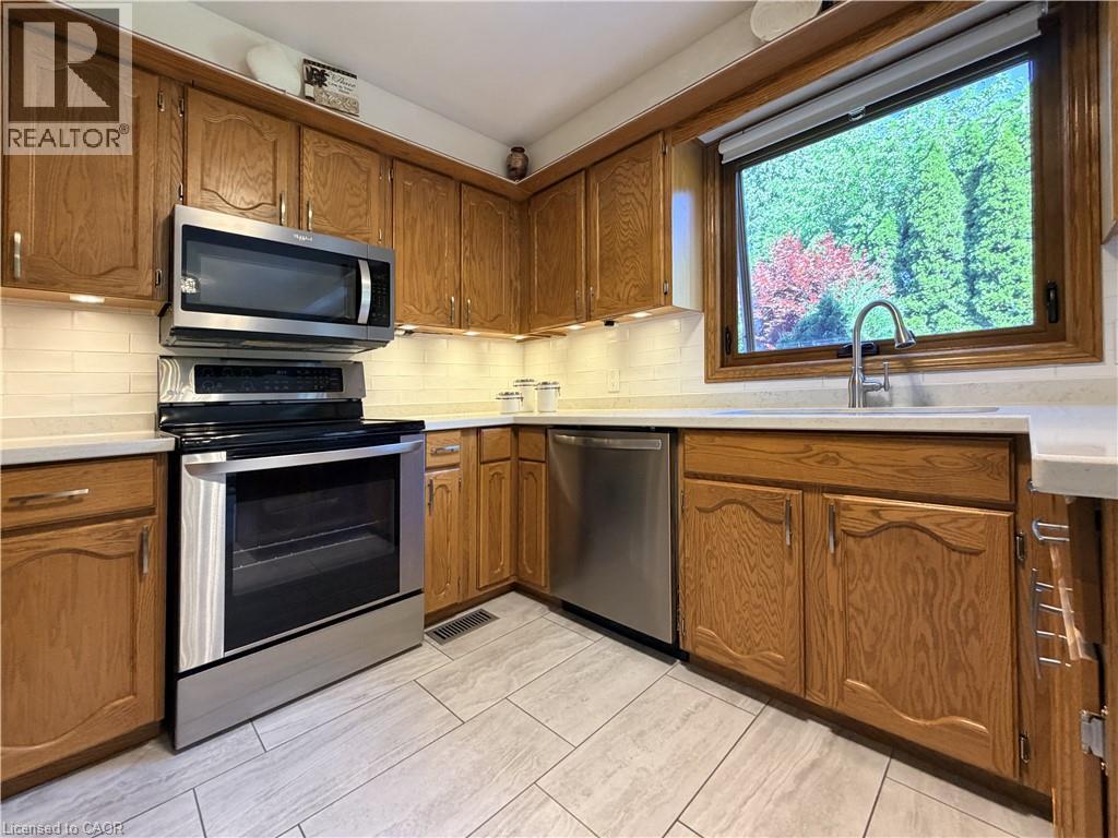 The kitchen window over the sink looks into the backyard. - 7 Mann Avenue, Simcoe, ON - Indoor Photo Showing Kitchen
