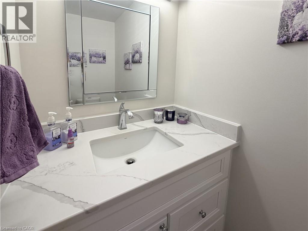Main floor powder room with quartz counter. - 7 Mann Avenue, Simcoe, ON - Indoor Photo Showing Bathroom