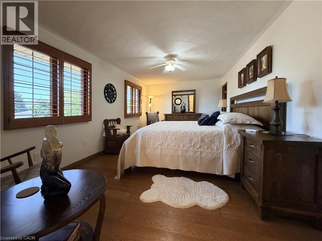 Hardwood flooring complementing white walls. - 7 Mann Avenue, Simcoe, ON - Indoor Photo Showing Bedroom