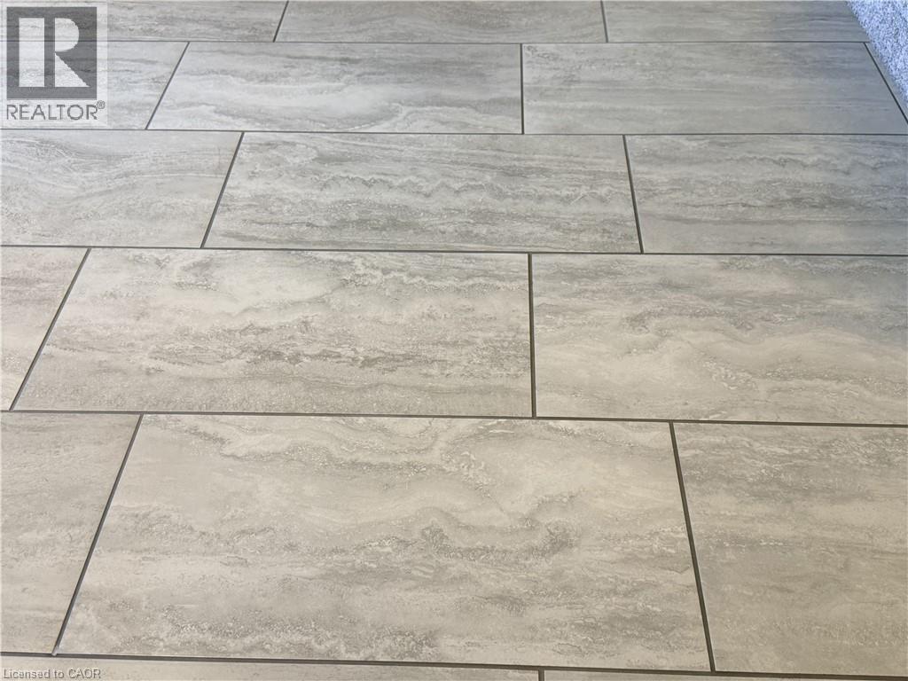 New flooring throughout oversize tiles.Solid wood interior doors, central vacuum, custom window coverings including California shutters, and quality finishes throughout reflect the pride of ownership - 7 Mann Avenue, Simcoe, ON -