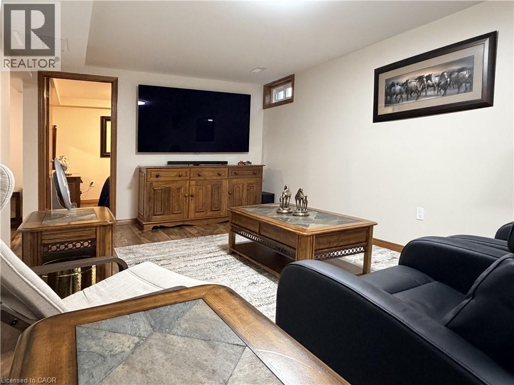 Basement family room doubles as a media room and a gym. - 7 Mann Avenue, Simcoe, ON - Indoor Photo Showing Living Room