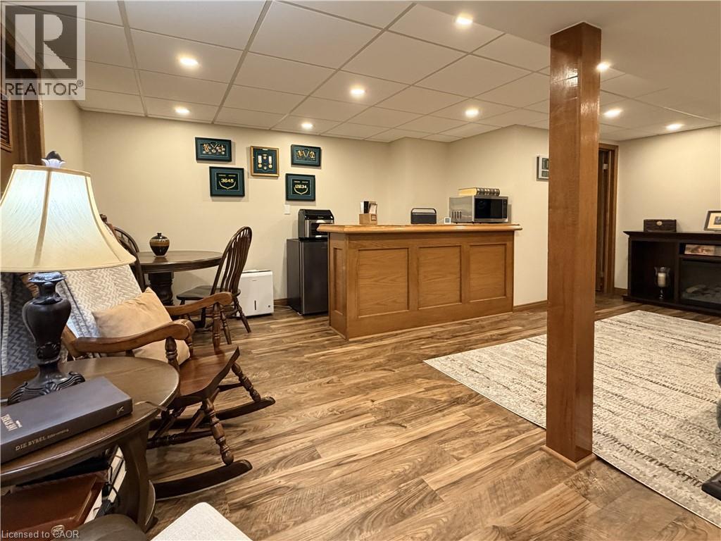 Basement games room with bar, new drop ceiling panels and pot lights. - 7 Mann Avenue, Simcoe, ON - Indoor