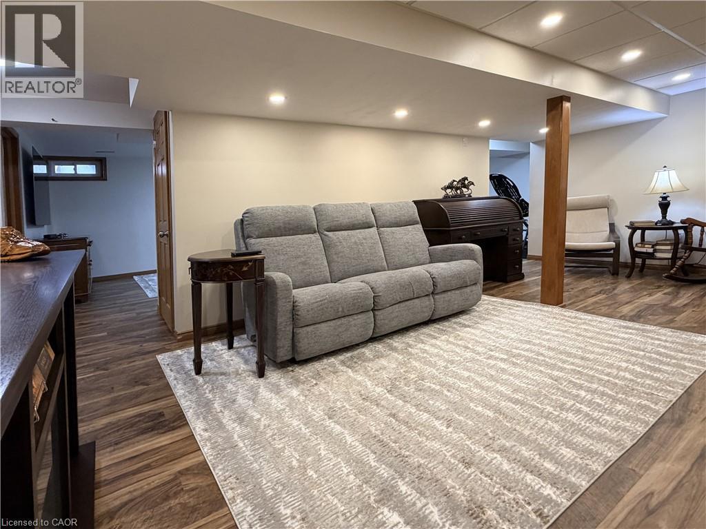 Game room features an electric fireplace and a bar. - 7 Mann Avenue, Simcoe, ON - Indoor