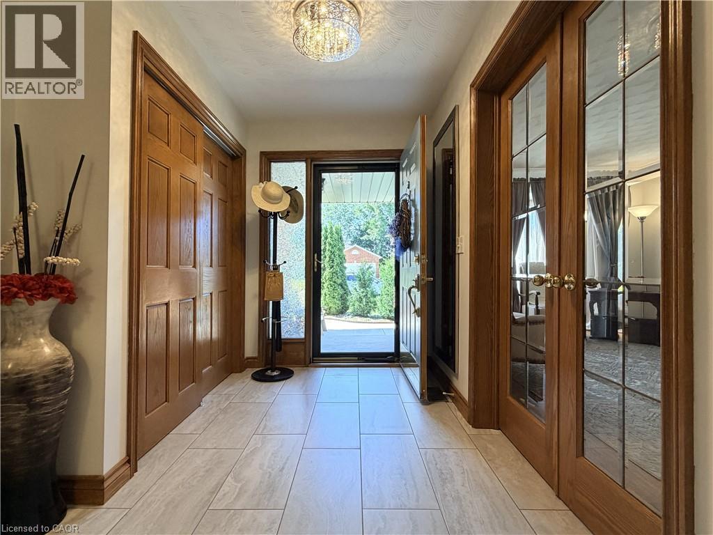 Wide, inviting entrance with double coat closet and glass doors to the Living Room. - 7 Mann Avenue, Simcoe, ON - Indoor Photo Showing Other Room