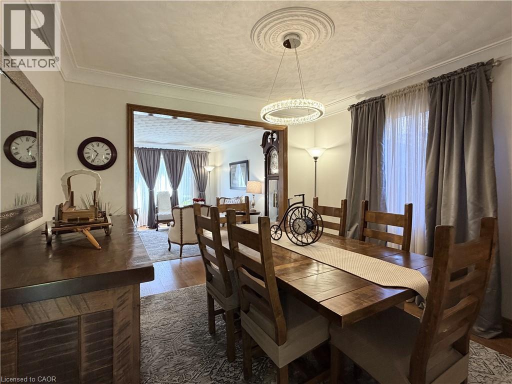 Formal Dining Room features hardwood flooring, new lighting and has an entrance to the eat in kitchen. - 7 Mann Avenue, Simcoe, ON - Indoor Photo Showing Dining Room