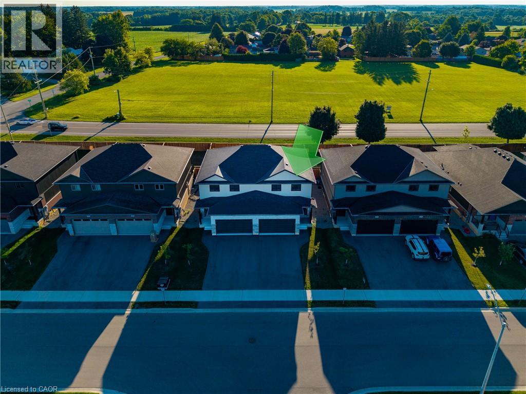 Modern two-story residence featuring a dark-toned facade, a contrasting light-toned upper level, and a prominent double garage - 107 Amber Street, Waterford, ON - Outdoor