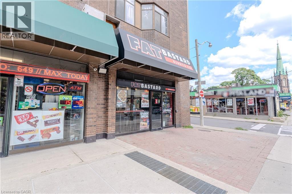 Street-level commercial space featuring brick facade and prominent storefront windows - 96 Gerrard St E, Toronto, ON
