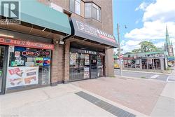 Street-level commercial space featuring brick facade and prominent storefront windows -