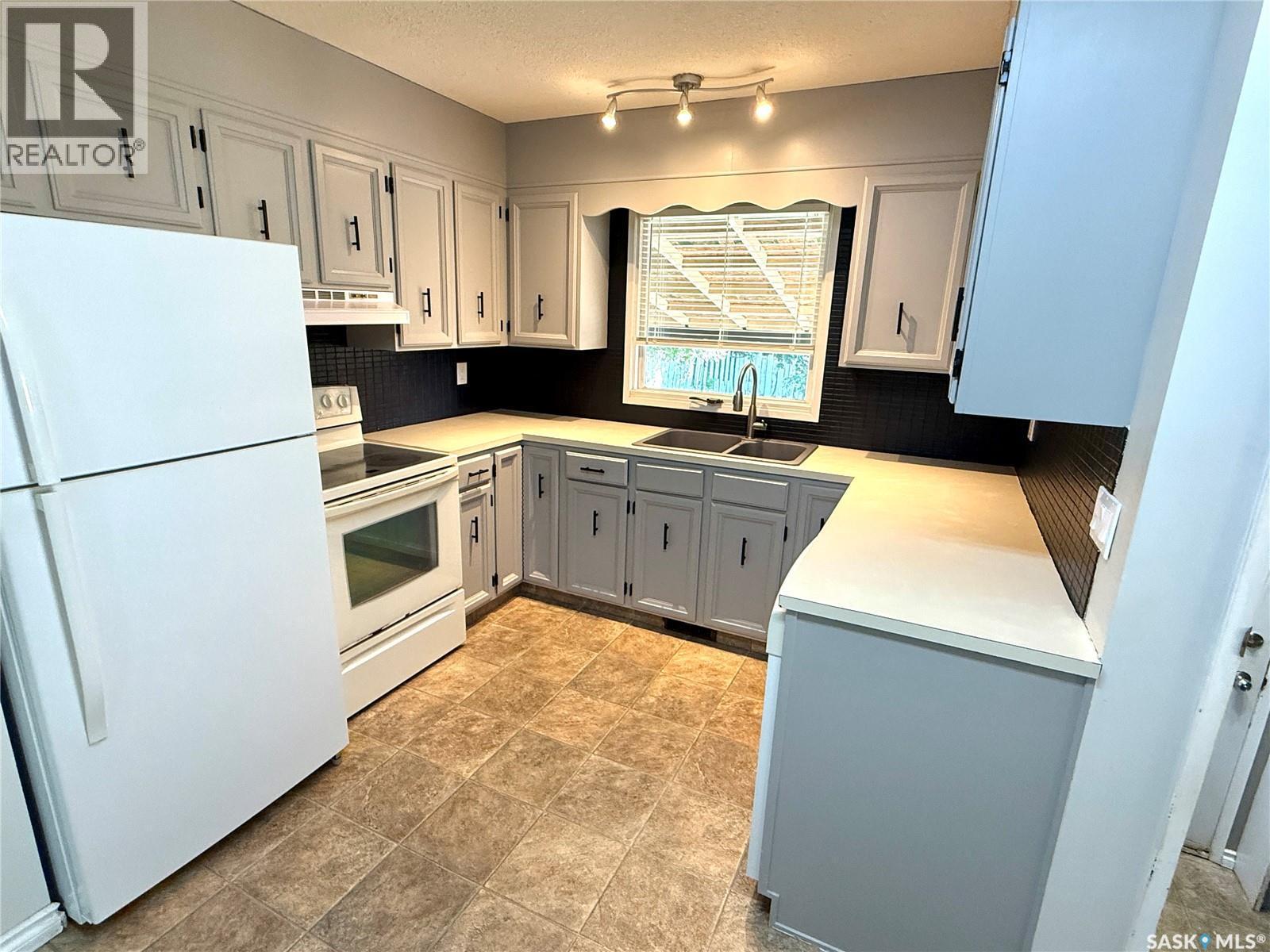 9026 Mitchell Avenue, North Battleford, SK - Indoor Photo Showing Kitchen With Double Sink