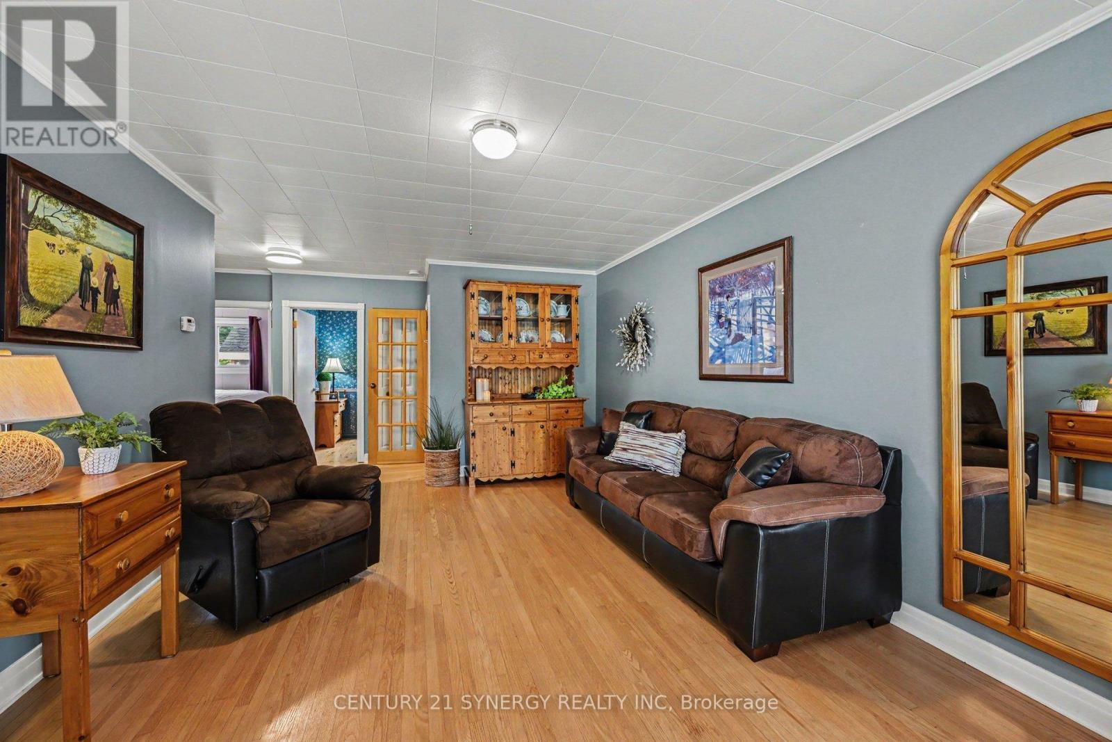 Spacious living room with original hardwood floors - 5 Queen Street, Smiths Falls, ON - Indoor Photo Showing Other Room