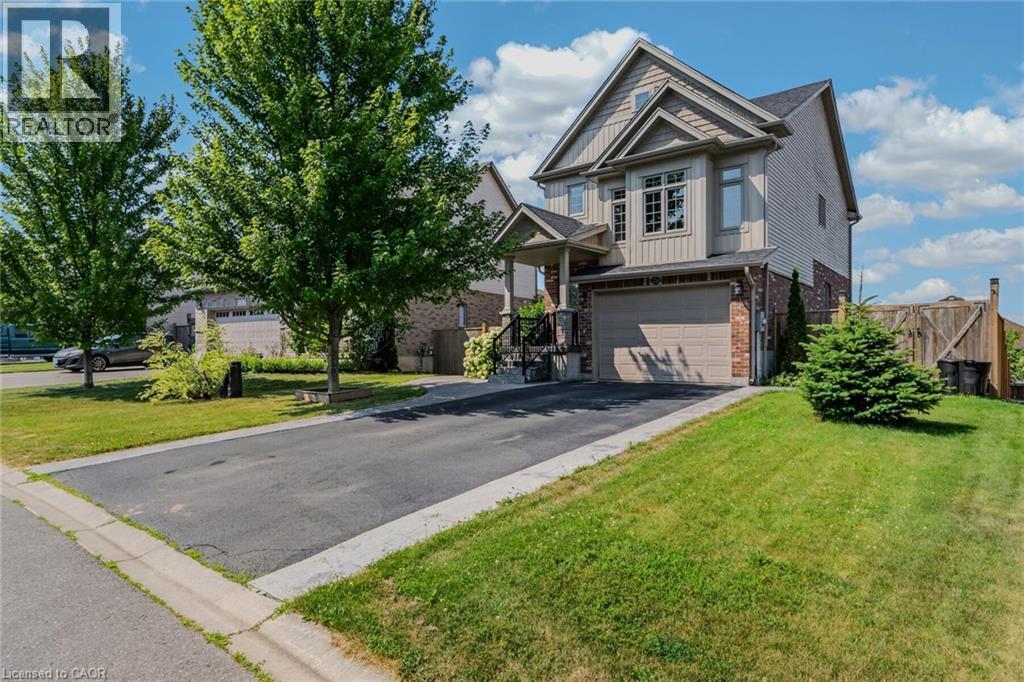 Two-story residence featuring light-colored siding and brick accents - 174 Woodway Trail, Simcoe, ON - Outdoor With Facade