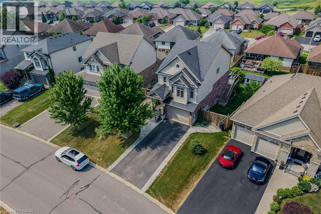 Two-story residence featuring a combination of brick and siding, a two-car garage, and a paved driveway - 174 Woodway Trail, Simcoe, ON - Outdoor With View