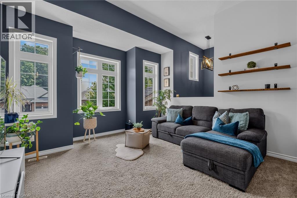 Living area featuring plush carpeting and a modern aesthetic - 174 Woodway Trail, Simcoe, ON - Indoor Photo Showing Living Room