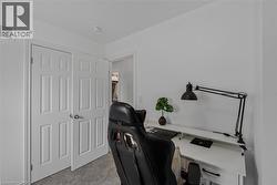 Bright interior space featuring white walls, textured carpeting, and white panel doors with brushed nickel hardware -