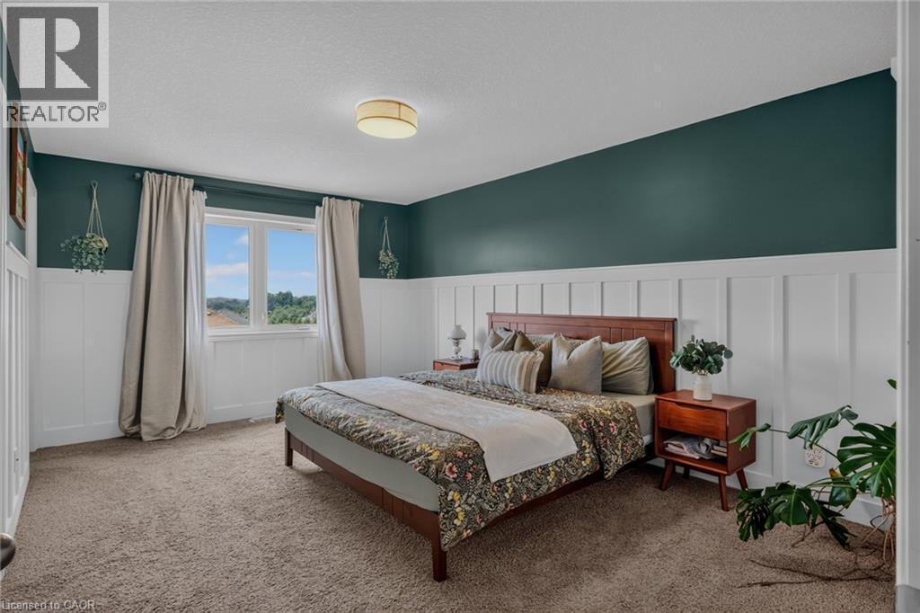 Bedroom featuring a window with natural light, board and batten wainscoting, and carpet flooring - 174 Woodway Trail, Simcoe, ON - Indoor Photo Showing Bedroom