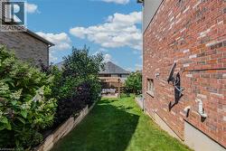 Manicured lawn area with a wooden retaining wall and established plantings -