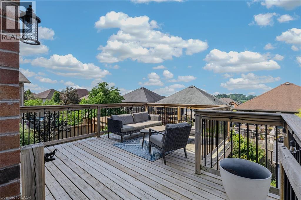Wood-finish decking with wood railing and black balusters - 174 Woodway Trail, Simcoe, ON - Outdoor With Deck Patio Veranda