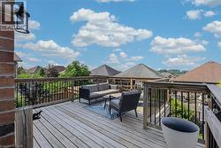 Wood-finish decking with wood railing and black balusters -