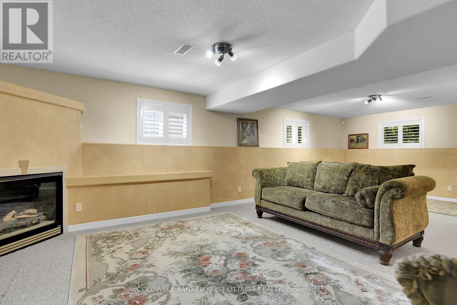 6983 Lakes Park Drive, Ottawa, ON - Indoor Photo Showing Basement With Fireplace