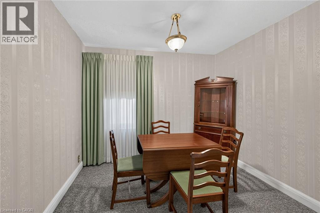 Interior room featuring striped wallpaper, carpet flooring, and white baseboards - 155 Newlands Avenue, Hamilton, ON - Indoor Photo Showing Other Room