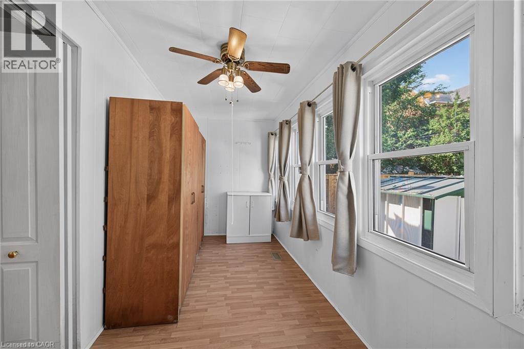 Interior room featuring wood-finish flooring, white walls, and a ceiling fan with light fixture - 155 Newlands Avenue, Hamilton, ON - Indoor Photo Showing Other Room