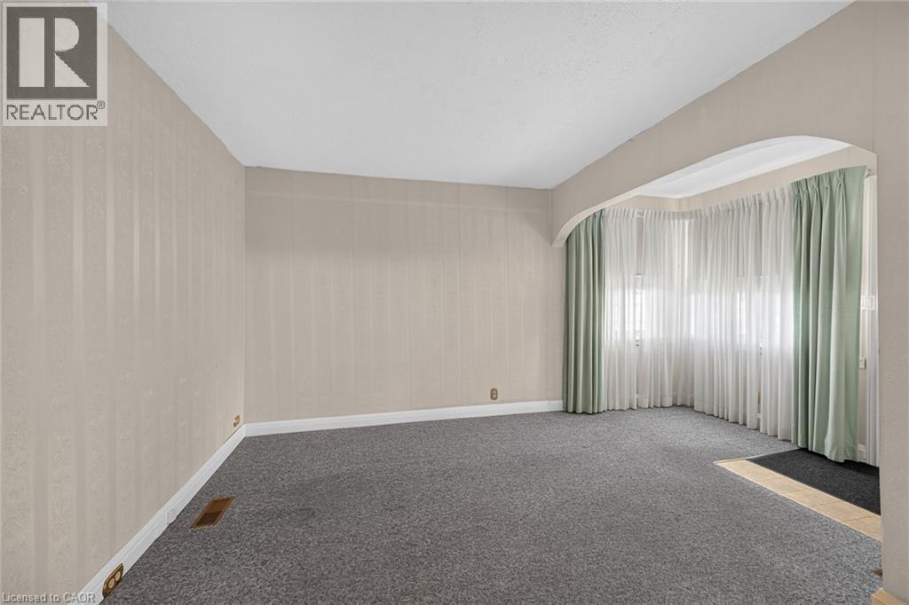 Room featuring light-toned striped wallpaper, gray carpeting, and white baseboards - 155 Newlands Avenue, Hamilton, ON - Indoor Photo Showing Other Room