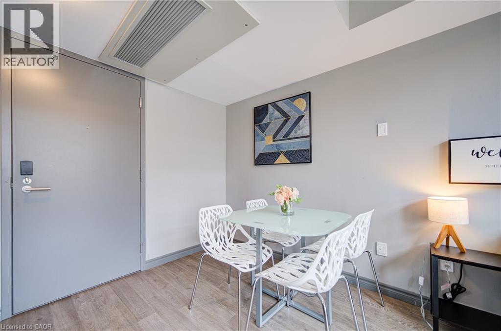 Interior space featuring wood-finish flooring, light gray walls, and a recessed ceiling vent - 321 Spruce Street Unit# 710, Waterloo, ON - Indoor Photo Showing Dining Room