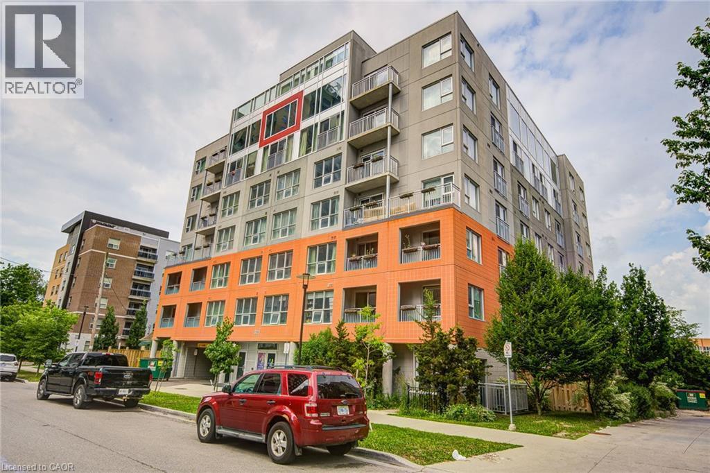 Modern multi-story building featuring a distinctive orange and gray facade - 321 Spruce Street Unit# 710, Waterloo, ON - Outdoor With Facade