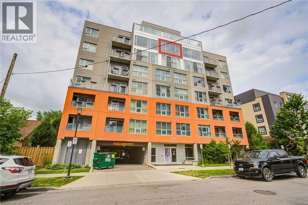 Modern multi-story building featuring a distinctive orange and gray facade - 321 Spruce Street Unit# 710, Waterloo, ON - Outdoor With Facade