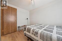 Well-lit room with wood-finish flooring and a textured ceiling -