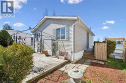 Exterior siding with decorative window shutters and a wooden deck -