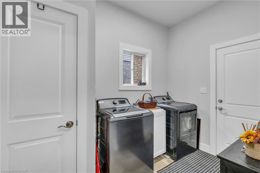 Dedicated laundry area with light gray walls, white trim, and a small window - 2195 Ironwood Road, London, ON - Indoor Photo Showing Laundry Room