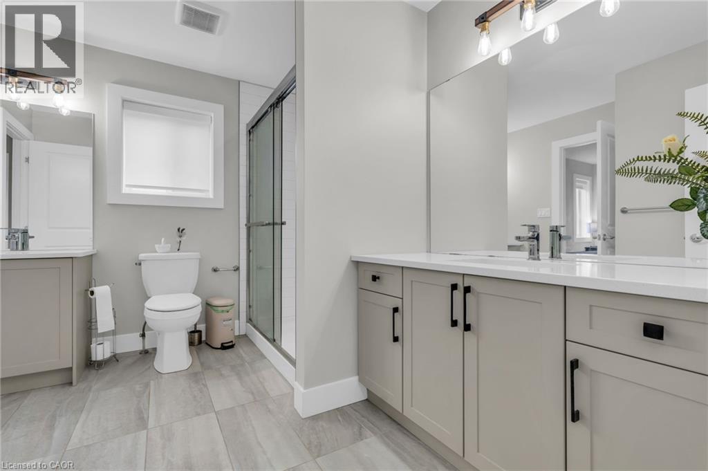 Contemporary bathroom featuring a double vanity with light gray cabinetry, white countertops, and chrome fixtures - 2195 Ironwood Road, London, ON - Indoor Photo Showing Bathroom