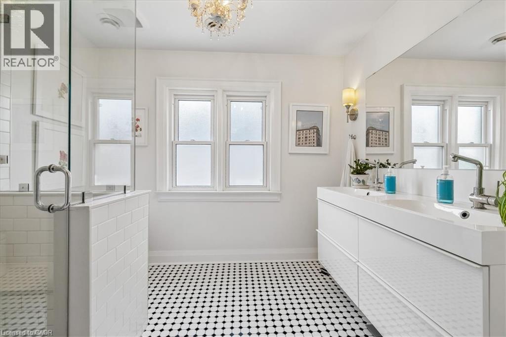 White bathroom featuring black and white hexagonal floor tiling - 573 Beach Boulevard, Hamilton, ON - Indoor Photo Showing Bathroom