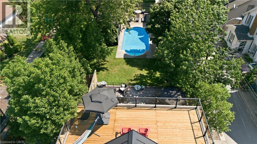 Expansive rooftop terrace with wood-finish decking and glass railings - 573 Beach Boulevard, Hamilton, ON - Outdoor