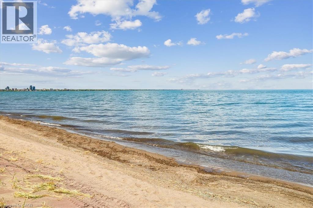 Sandy shoreline with gentle waves - 573 Beach Boulevard, Hamilton, ON - Outdoor With Body Of Water With View